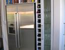 Made to measure built in fridge unit with wine rack.